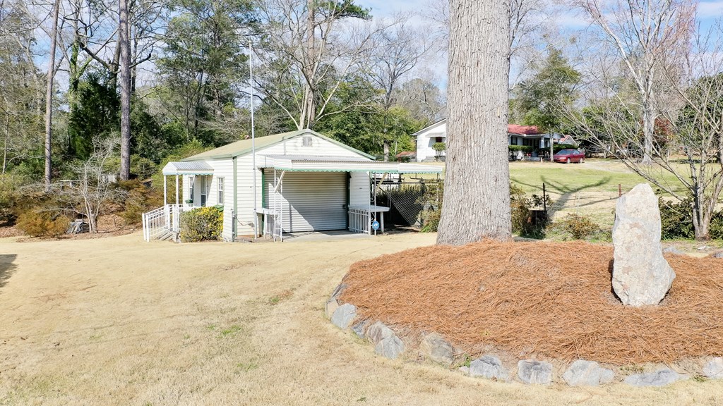4315 Macon Road Columbus, GA 31907 - Photo 22 of 37 a front view of a house with a yard and trees