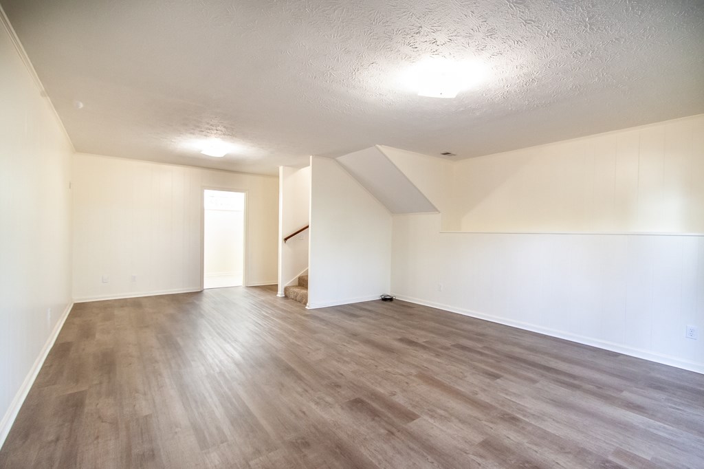 4315 Macon Road Columbus, GA 31907 - Photo 3 of 37 an empty room with wooden floor and windows
