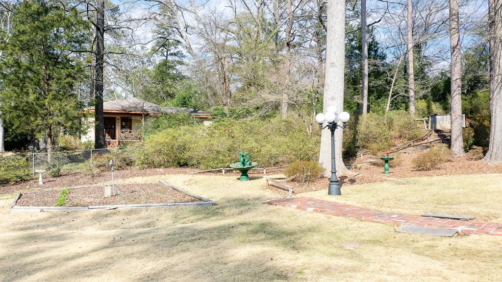 4315 Macon Road Columbus, GA 31907 - Photo 35 of 37 a backyard of a house with table and chairs under an umbrella