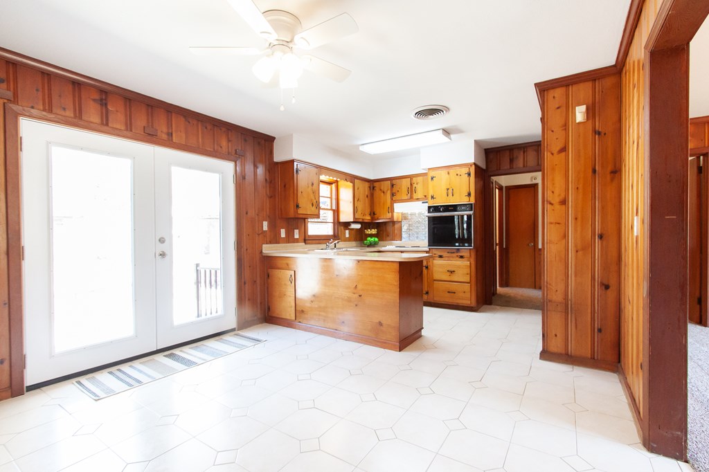 4315 Macon Road Columbus, GA 31907 - Photo 7 of 37 a kitchen with stainless steel appliances granite countertop a refrigerator a oven a sink with island and chairs