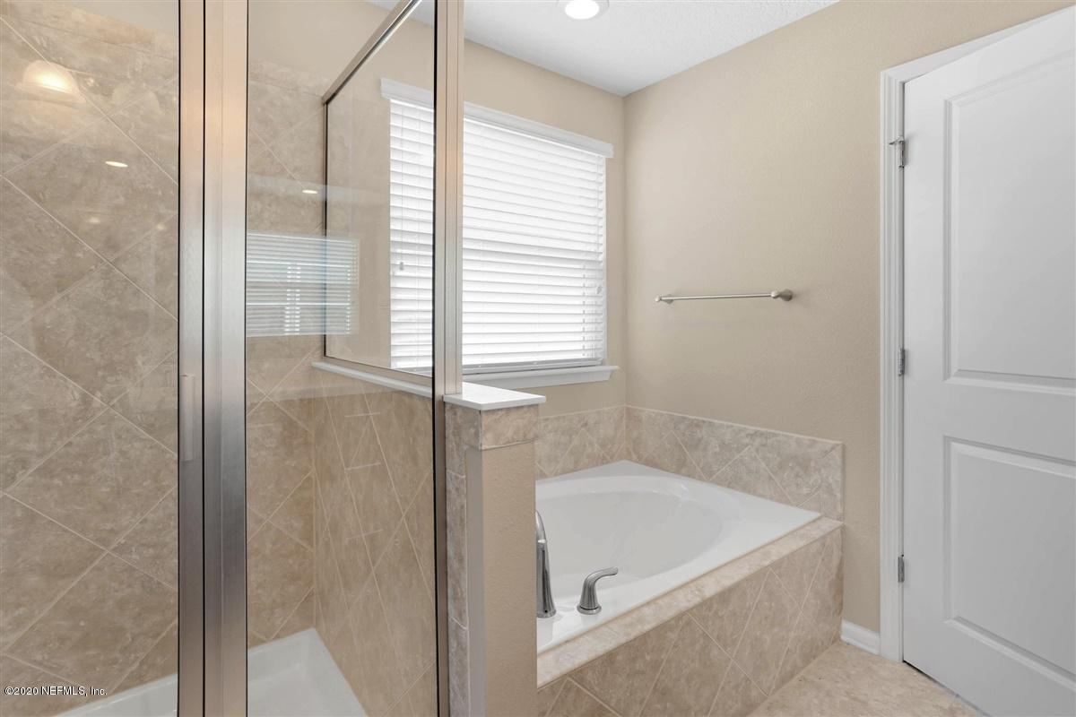 6775 Azalea Park Road Jacksonville, FL 32259 - Photo 14 of 22 a bathroom with a tub shower and a sink