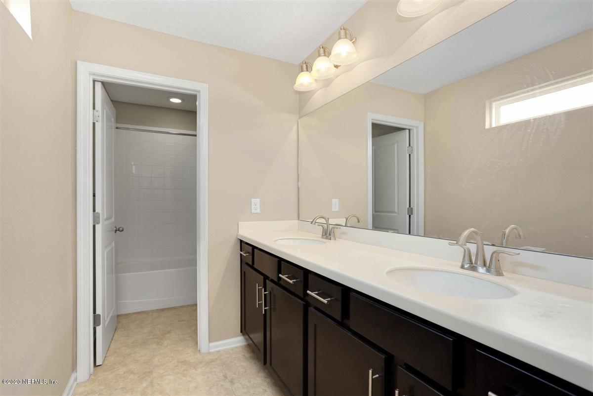 6775 Azalea Park Road Jacksonville, FL 32259 - Photo 17 of 22 a bathroom with a double vanity sink a and a mirror