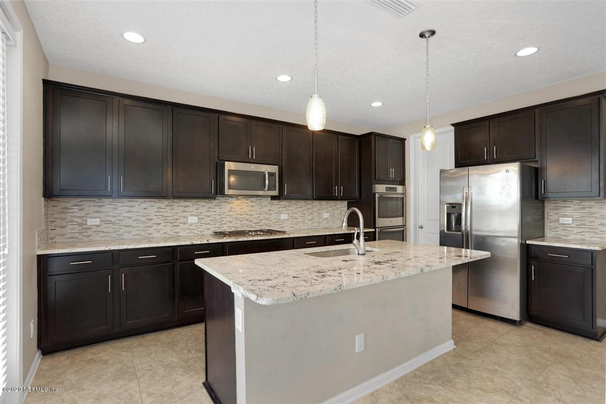 6775 Azalea Park Road Jacksonville, FL 32259 - Photo 6 of 22 a kitchen with stainless steel appliances granite countertop a sink stove and refrigerator