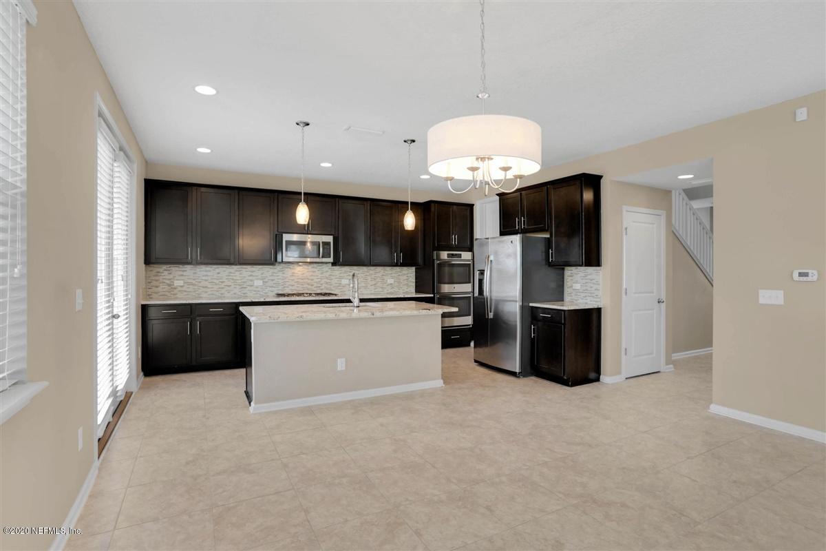 6775 Azalea Park Road Jacksonville, FL 32259 - Photo 7 of 22 a large kitchen with a large counter top stainless steel appliances and cabinets