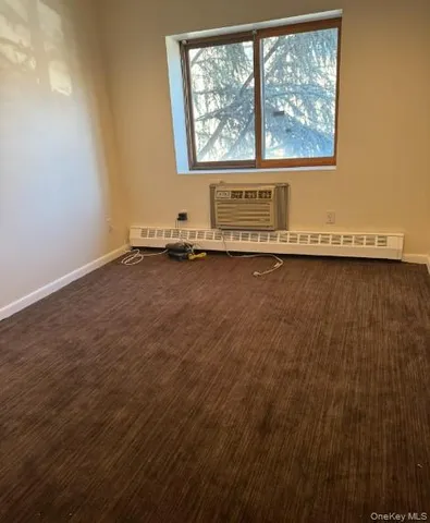 a front view of a house with plants and trees