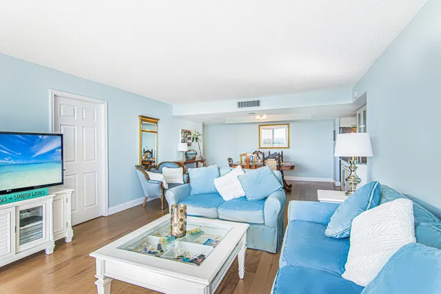 a living room with furniture fireplace and wooden floor