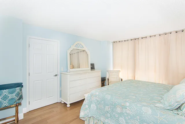 a bedroom with a bed and a mirror