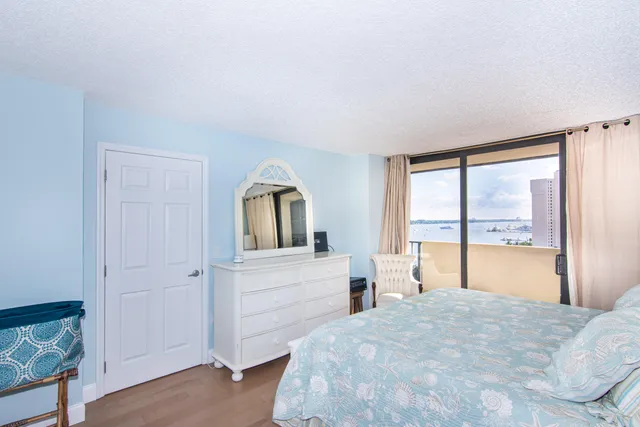 a bedroom with a bed and a large window