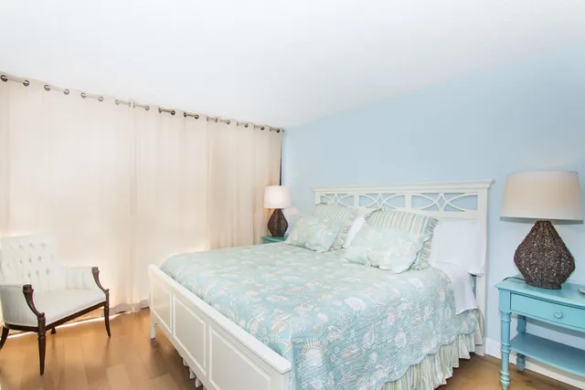 a bedroom with a bed and a chair