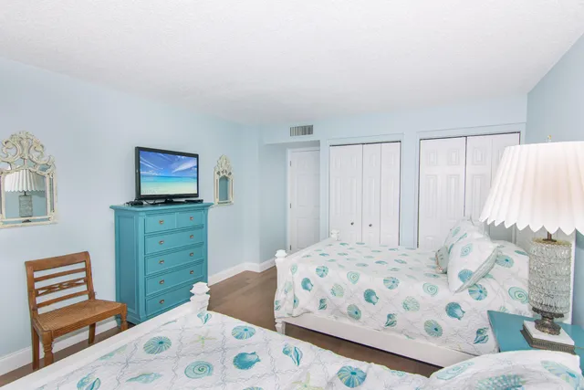 a bedroom with a bed and a dresser in it