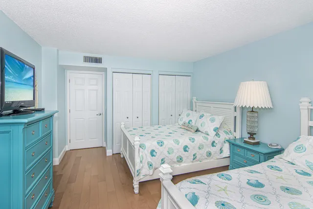 a bedroom with a bed and a dresser in it