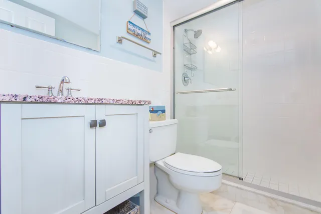 a bathroom with a toilet a sink and shower