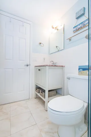 a bathroom with a sink a toilet and vanity