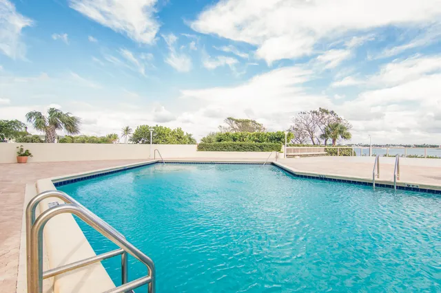 a view of a swimming pool with a lawn chairs