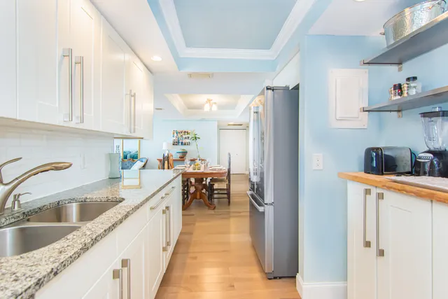 a kitchen with stainless steel appliances granite countertop a refrigerator and a sink