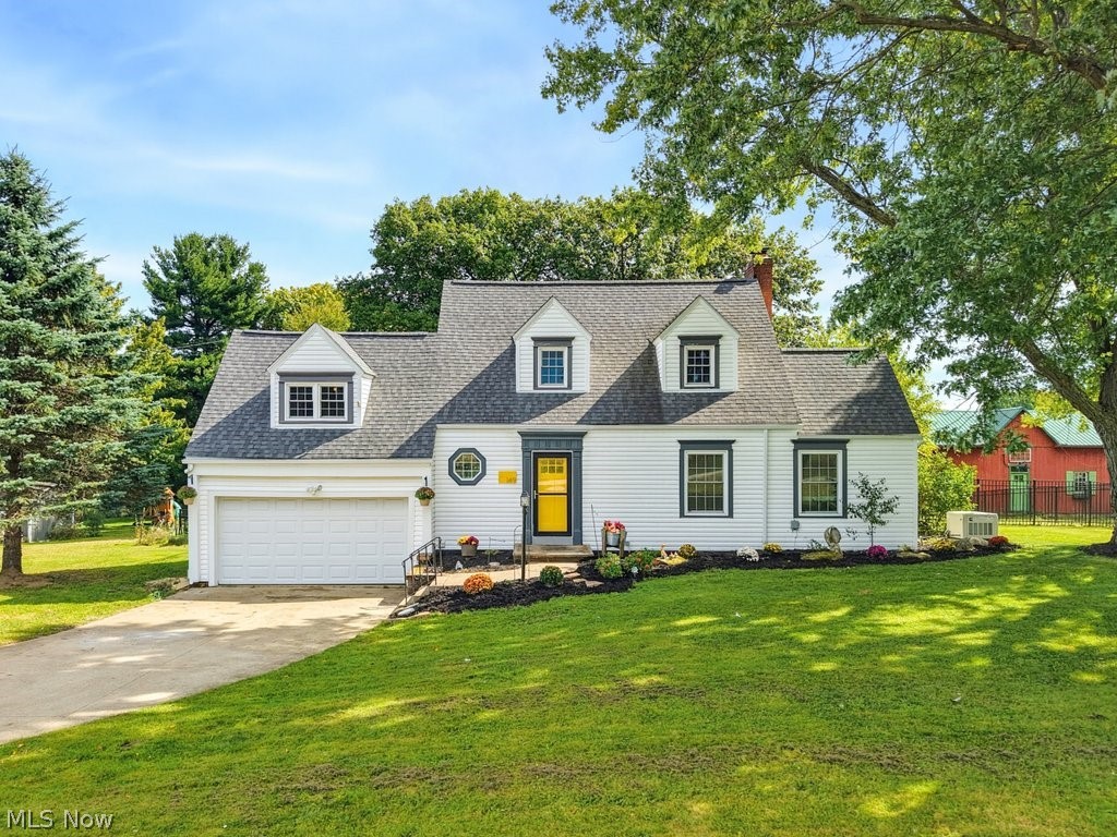 149 North Medina Line Road Akron, OH 44333 - Photo 1 of 42 White siding exterior with a dark shingle roof, multiple dormer windows, and a prominent attached garage