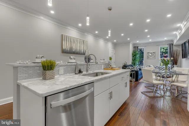a kitchen with center island table and chairs