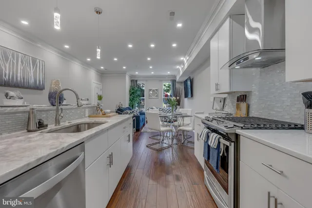a kitchen with sink stove and cabinets