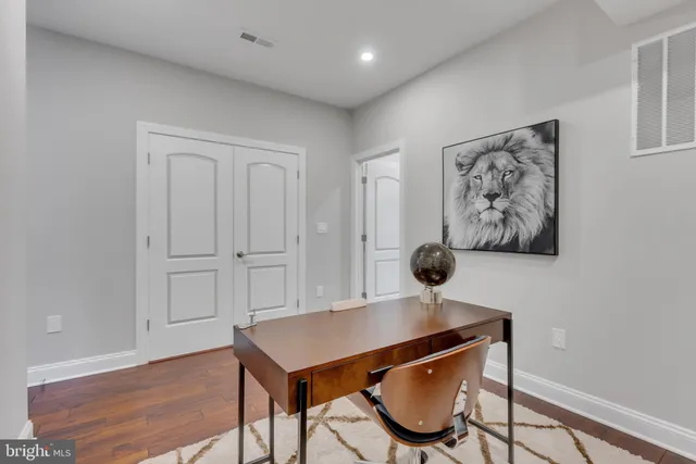 a view of a workspace room with wooden floor