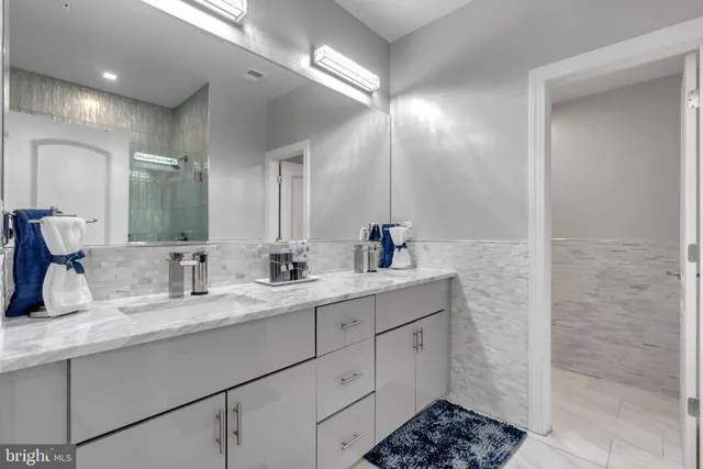 a bathroom with a double vanity sink and a mirror
