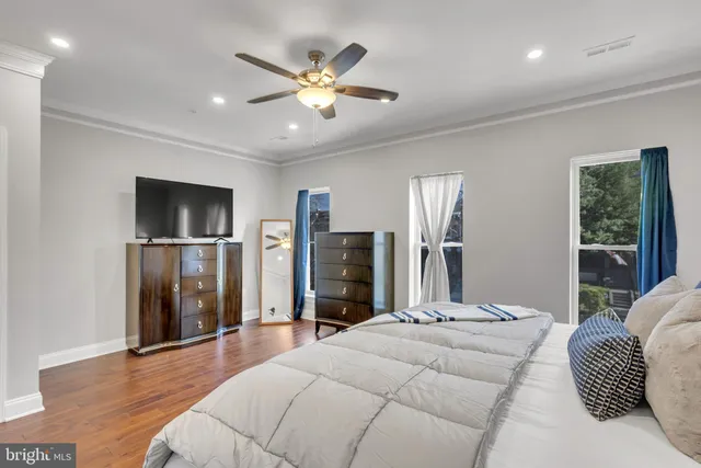 a bedroom with a large bed and a chandelier