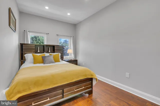 a bed sitting in a bedroom next to a window