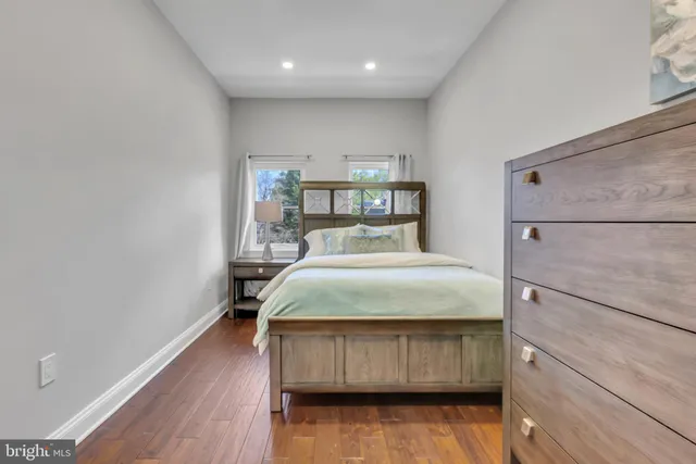 a bedroom with a bed and a wooden floor