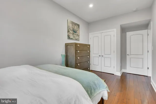 a bedroom with a bed and a painting on the wall