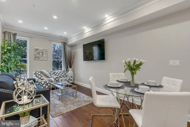 a dining room with furniture and wooden floor