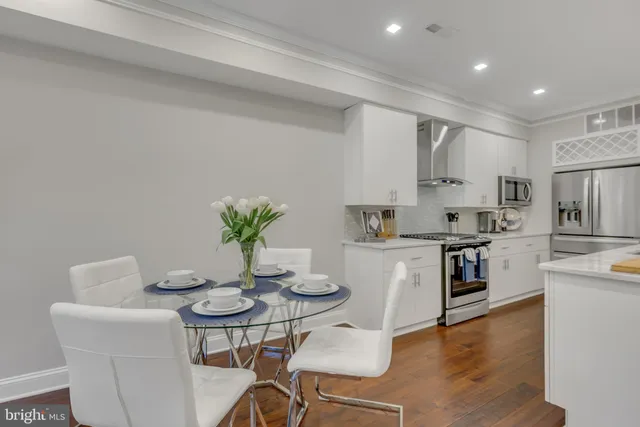 a kitchen with a table and chairs in it