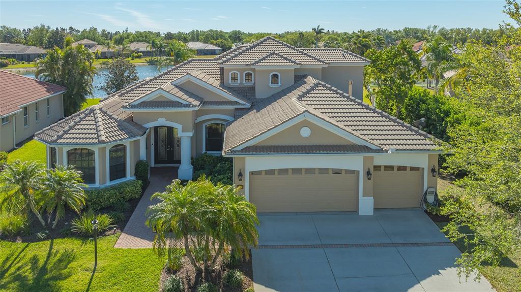 6915 Honeysuckle Trail Lakewood Ranch, FL 34202 - Photo 1 of 1 a aerial view of a house with a yard and potted plants