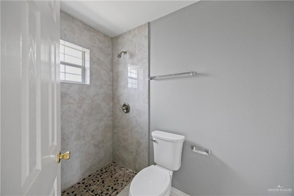 2205 North Erica Street Pharr, TX 78577 - Photo 13 of 21 a white toilet sitting next to a shower