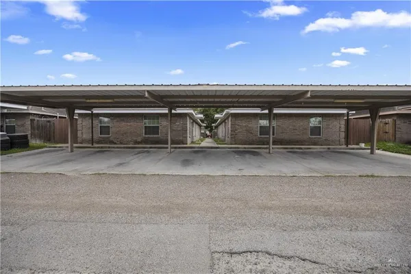 an aerial view of a house with a yard and a large tree