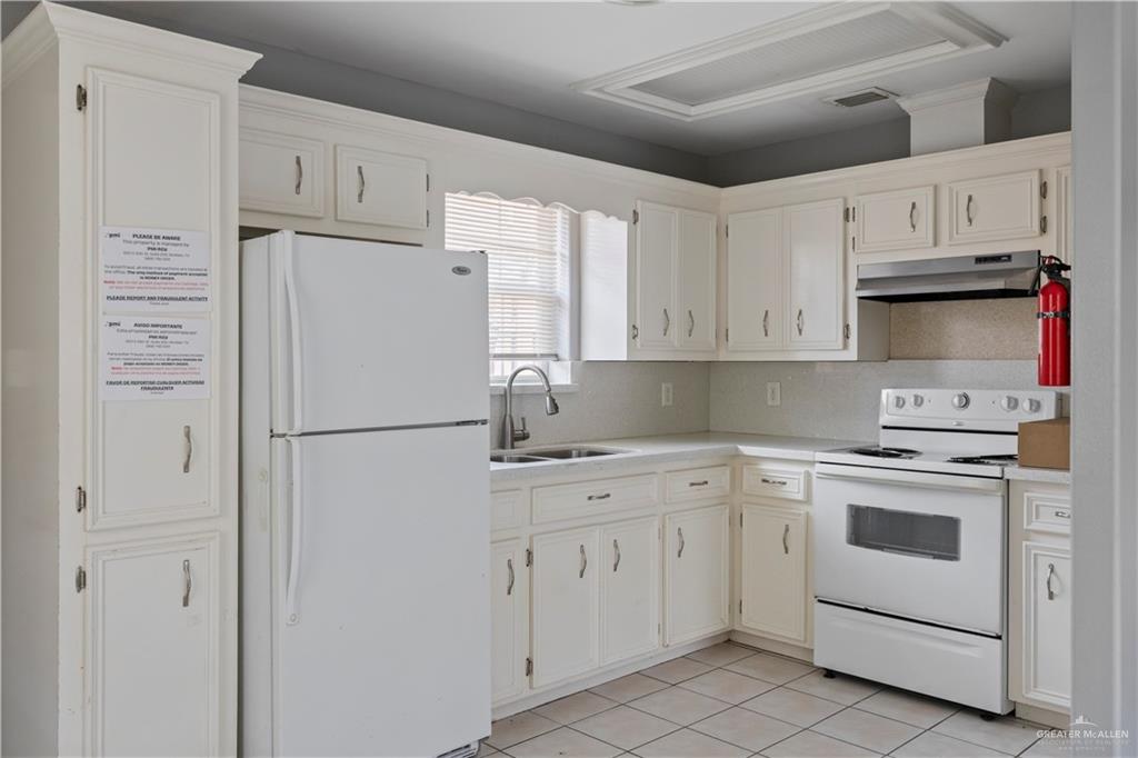 2205 North Erica Street Pharr, TX 78577 - Photo 6 of 21 a white refrigerator freezer sitting in a kitchen