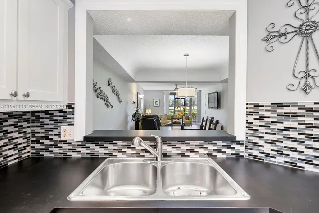 a kitchen with a sink and a stove top oven