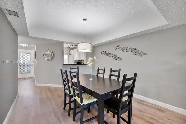a view of a dining room with furniture and wooden floor