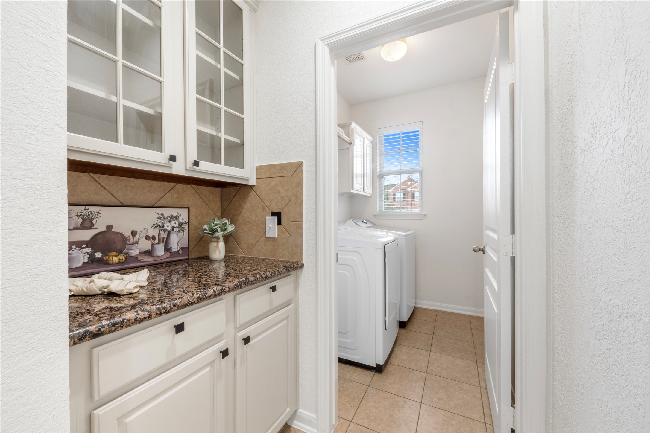 9535 Empress Crossing Drive Spring, TX 77379 - Photo 3 of 45 Butlers Pantry is the perfect spot for a coffee bar, smoothie station, or classic dry bar with plenty of storage. Stylish freshly painted glass front cabinets are the perfect accent to this space.