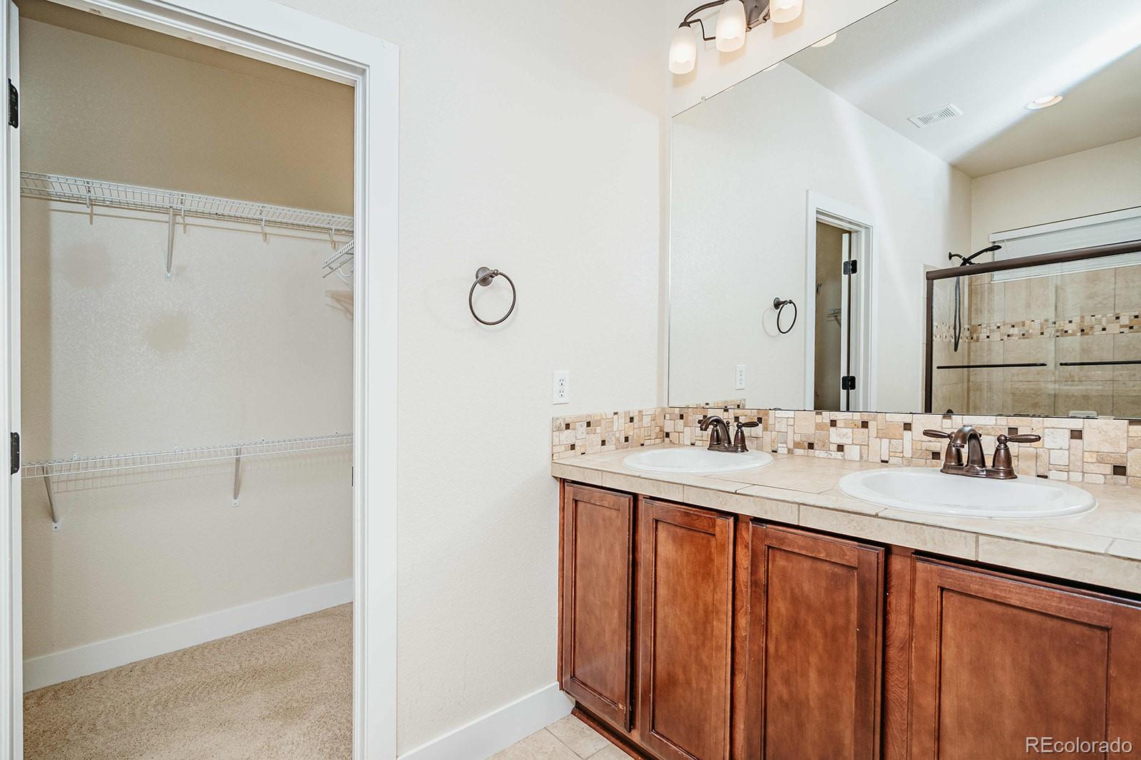 10608 Rutledge Street Parker, CO 80134 - Photo 11 of 24 a bathroom with a sink and a mirror