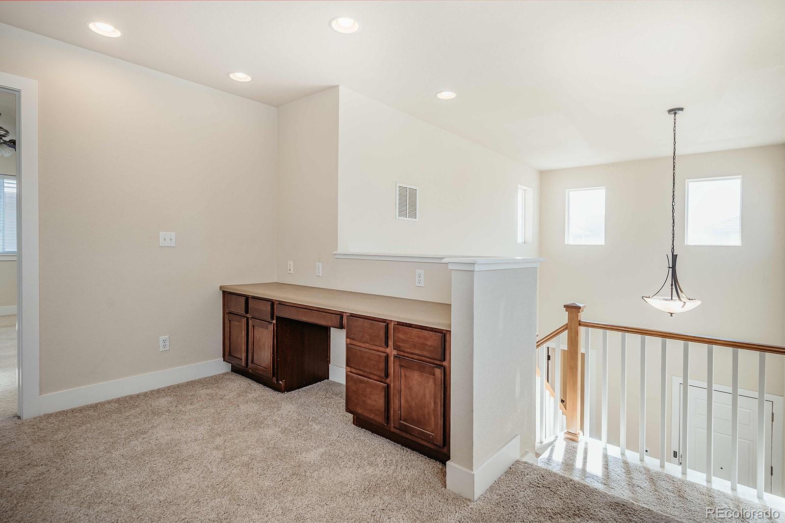 10608 Rutledge Street Parker, CO 80134 - Photo 14 of 24 a view of an empty room with wooden floor and a window