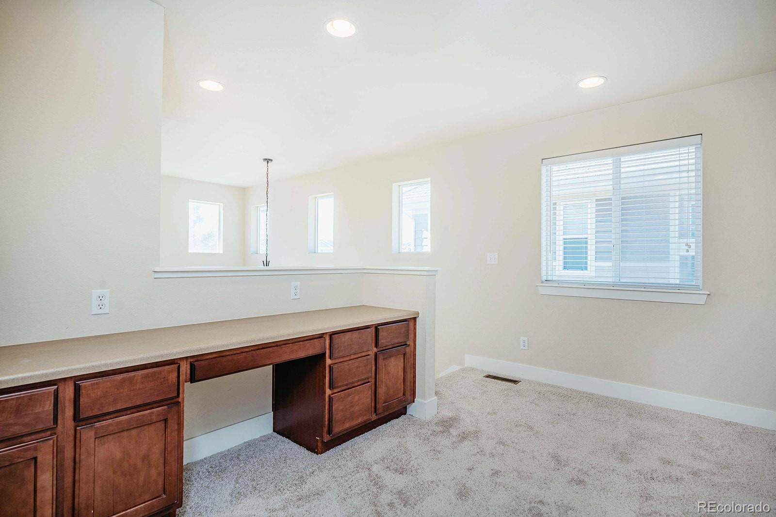 10608 Rutledge Street Parker, CO 80134 - Photo 15 of 24 a room with painting and a table