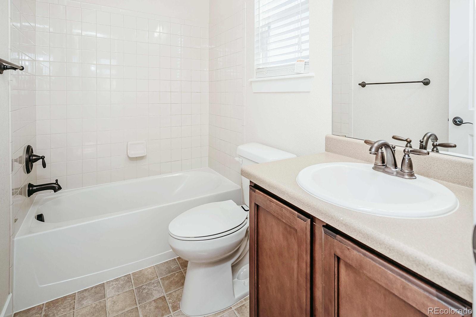 10608 Rutledge Street Parker, CO 80134 - Photo 17 of 24 a bathroom with a sink a toilet and a bathtub