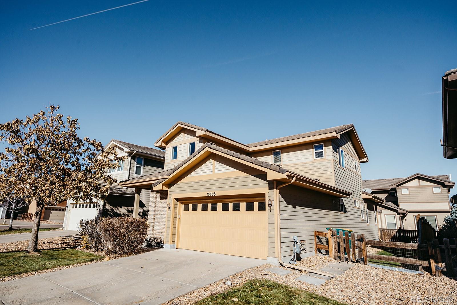 10608 Rutledge Street Parker, CO 80134 - Photo 2 of 24 a view of a house with a wooden fence