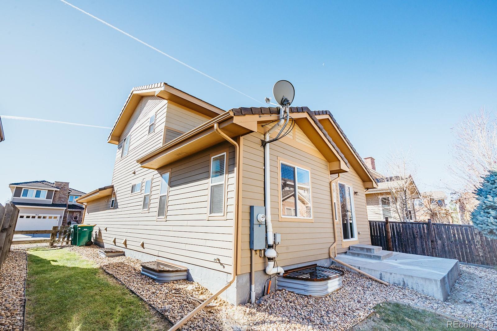 10608 Rutledge Street Parker, CO 80134 - Photo 24 of 24 a front view of a house with garden