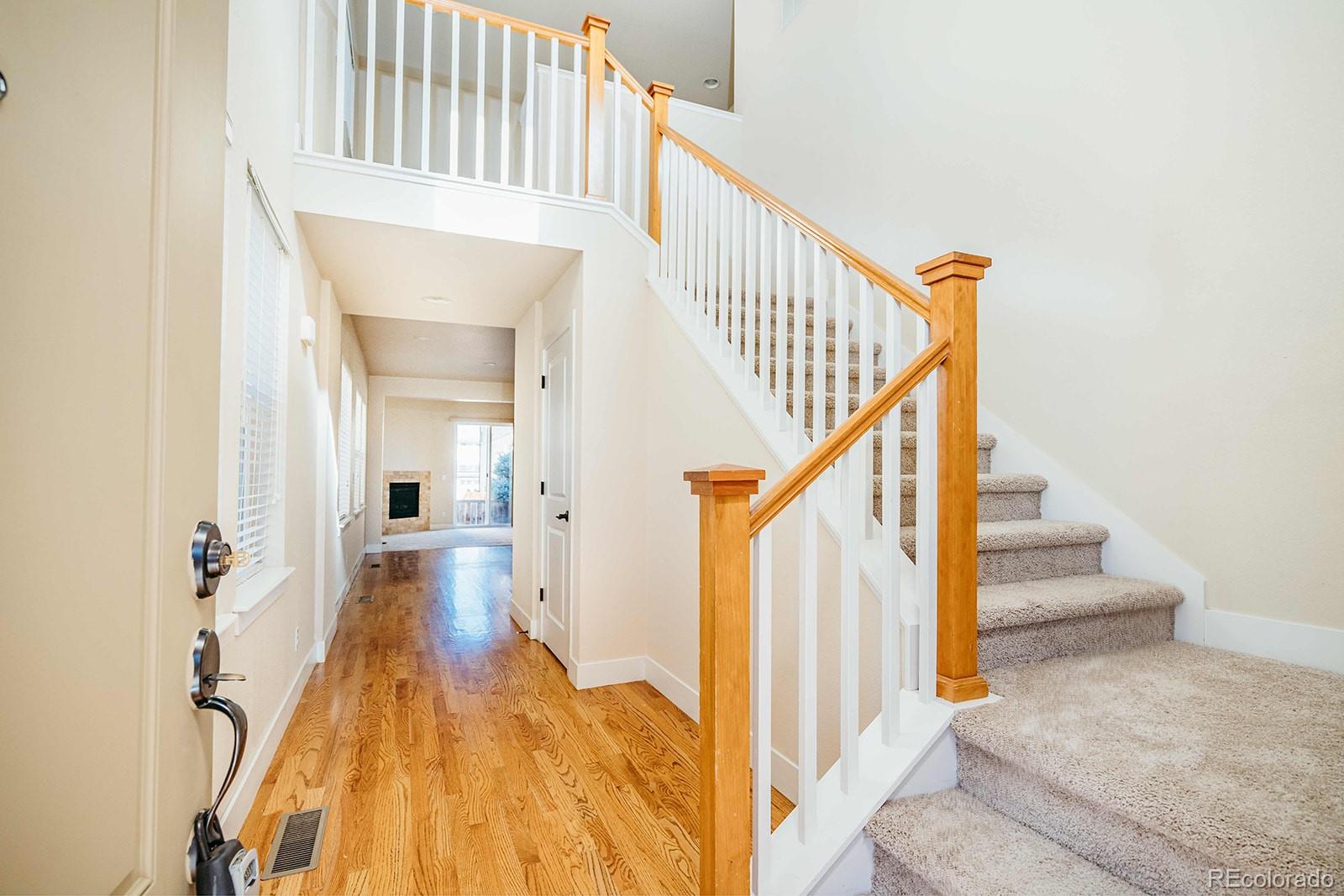 10608 Rutledge Street Parker, CO 80134 - Photo 3 of 24 a view of entryway and hall with wooden floor