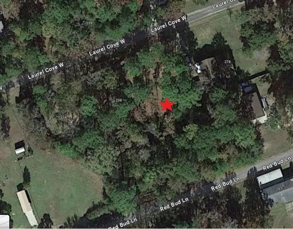 an aerial view of a house with lots of trees