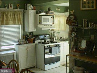 219 Powell Road Springfield, PA 19064 - Photo 3 of 6 a kitchen with a stove and cabinets
