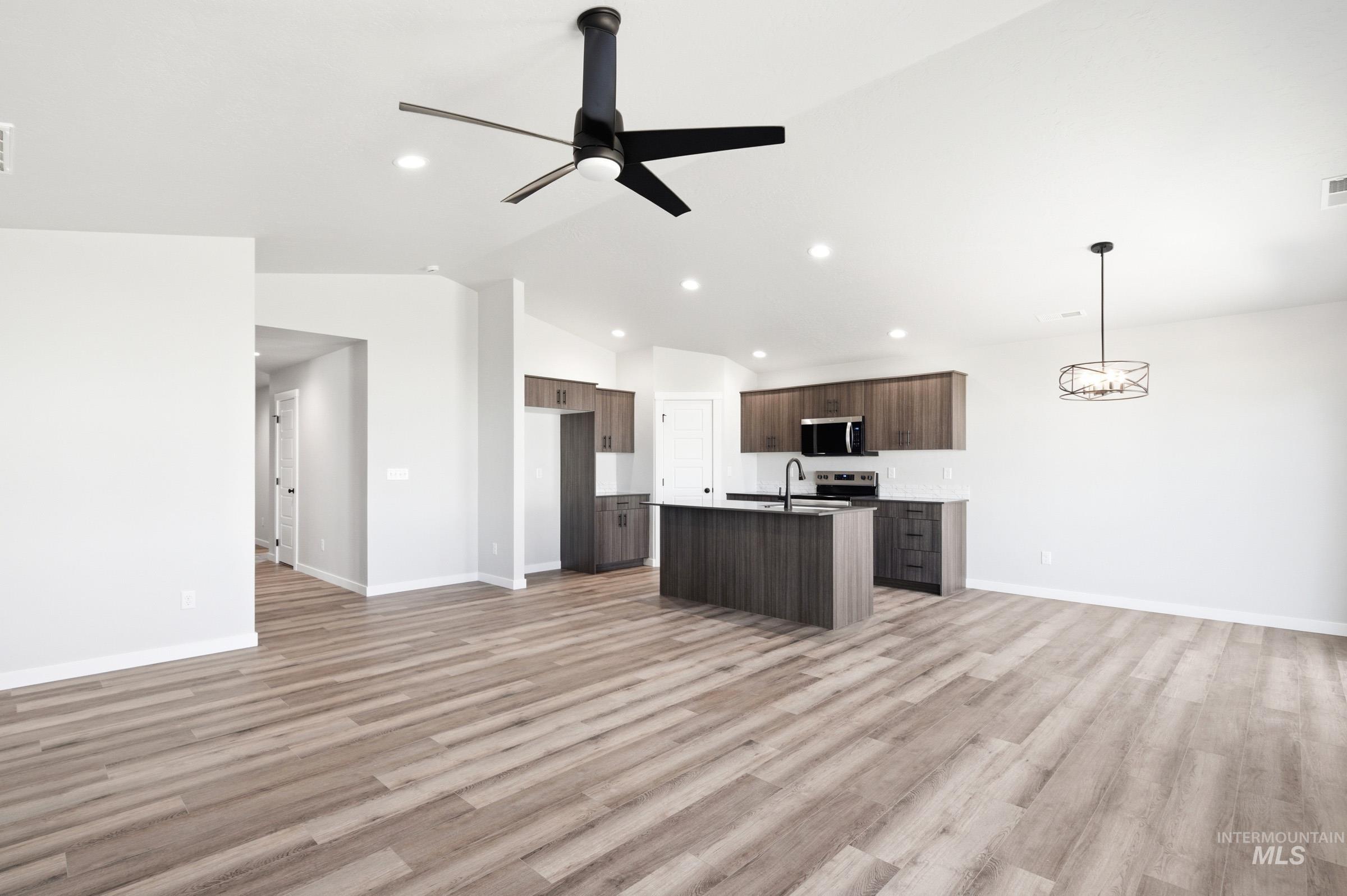 12805 Decatur Street Nampa, ID 83651 - Photo 11 of 20 Open-concept living space featuring wood-finish flooring, recessed lighting, and a modern ceiling fan