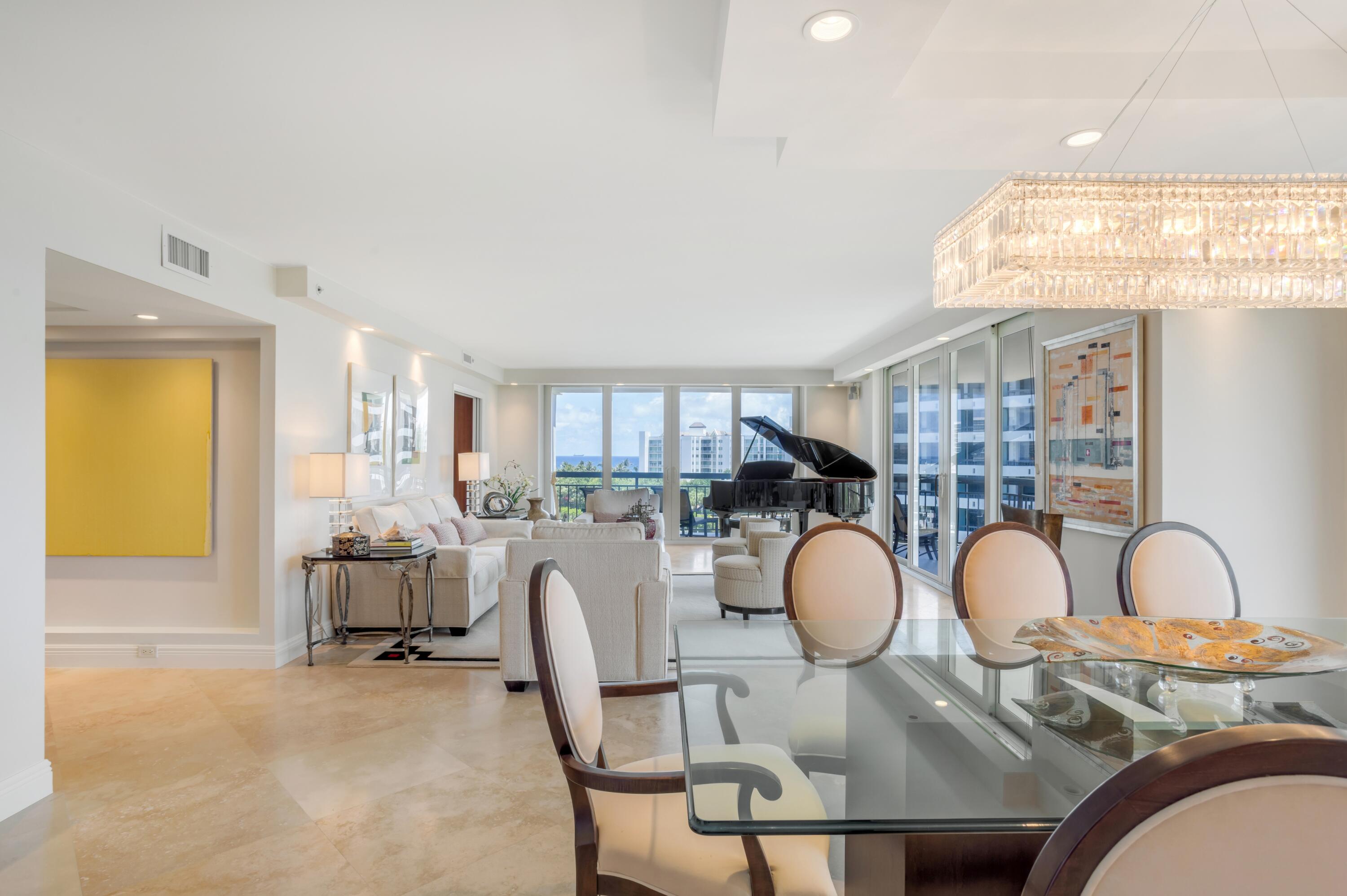901 East Camino Real, Unit 7C Boca Raton, FL 33432 - Photo 16 of 41 a view of a dining room with furniture and a chandelier