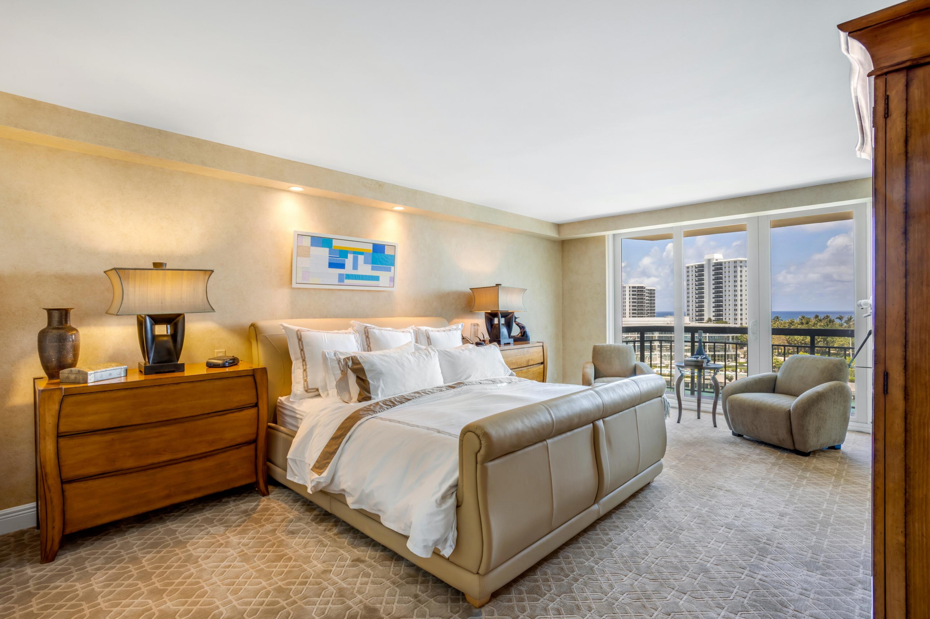 901 East Camino Real, Unit 7C Boca Raton, FL 33432 - Photo 23 of 41 a bedroom with bed lamp and window