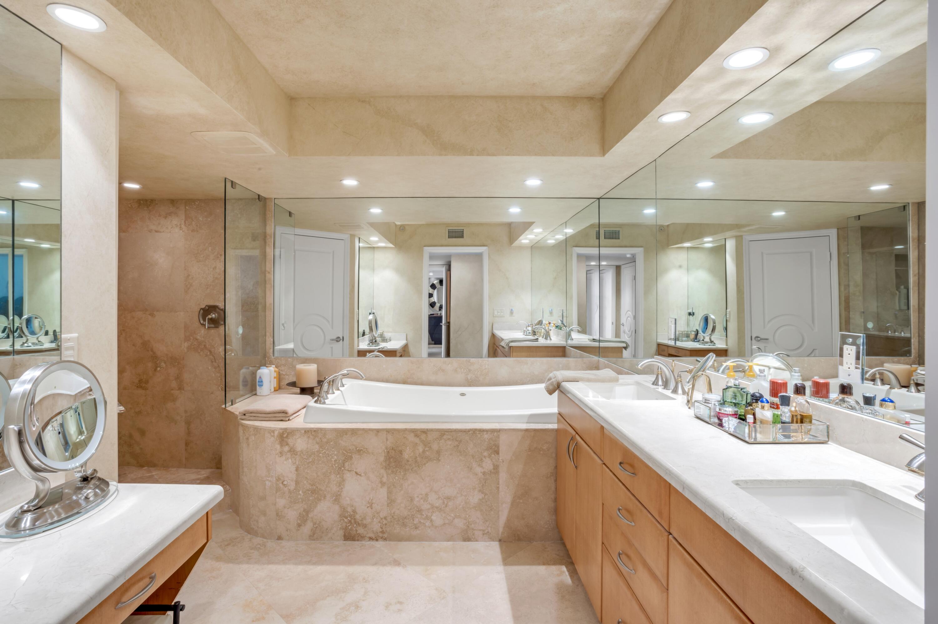 901 East Camino Real, Unit 7C Boca Raton, FL 33432 - Photo 26 of 41 a spacious bathroom with a sink mirror and shower